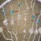 branches strung with clear glass beads and blue beaded accents